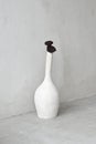 Stylish white vase over gray concrete wall, close-up. Empty room. Interior mock up. Vertical