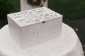 Stylish white wooden box with wedding word. Modern gift box for