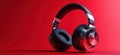 Stylish wireless headphones with sleek design and vibrant red background Royalty Free Stock Photo