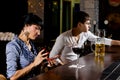 Stylish woman at the bar sending an sms message Royalty Free Stock Photo