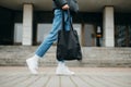 Stylish woman in bloodstains and jeans with a bag in hand, close photo of legs Royalty Free Stock Photo