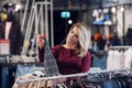 A stylish woman checking out new collection in a clothing store