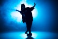 Stylish woman dancing solo on hip hop party. Sunglasses, smoke, neon lights. Royalty Free Stock Photo