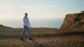 Stylish woman exploring coastline alone. Blonde woman spending vacation at sea