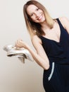 Stylish woman fashion girl holds high-heeled shoes