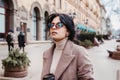 Stylish woman listning music on her airpods in city Royalty Free Stock Photo