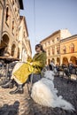 Woman sitting with her white dog at outdoor cafe in the old town of Bologna city Royalty Free Stock Photo