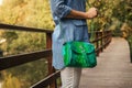 Stylish woman with snakeskin handbag outdoors.