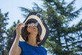 Stylish woman in a straw sunhat blowing bubbles Royalty Free Stock Photo