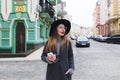 Stylish woman tourist strolling through the streets of the old town and smiling. A girl walking along the streets Royalty Free Stock Photo