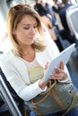 Stylish woman in tramway websurfing on tablet