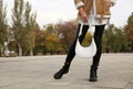 Stylish woman with trendy white baguette bag on city street, closeup Royalty Free Stock Photo