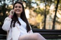 Stylish woman using smartphone in the park