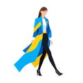 Stylish woman walking confidently in blue and yellow coat. Modern fashion, confident female stride. Empowered