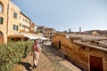 woman walks on background of cityscape of Siena old town in Italy