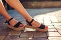 Stylish woman wearing black summer shoes with straw sole outdoors. Comfortable sandals. Beauty fashion. Royalty Free Stock Photo