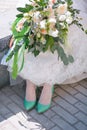 Stylish woman white dress bouquet green shoes