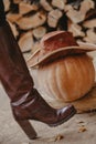 Women boot and pumpkin in leather hat Royalty Free Stock Photo