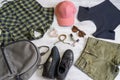 Stylish women`s or teenager`s clothing set with accessories: checkered shirt, black jersey top, green jeans shorts, pink cap, Royalty Free Stock Photo