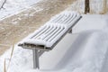 Snowy Wooden Bench in a Public Park