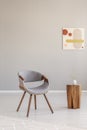 Stylish grey wooden chair in empty living room interior with trendy wooden coffee table Royalty Free Stock Photo