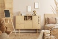 Stylish wooden commode with plush toy on top next to single bed in kid`s bedroom
