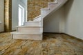 Stylish wooden contemporary staircase inside loft house interior. Modern hallway with decorative limestone brick walls and white Royalty Free Stock Photo