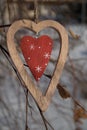 Stylish wooden heart Closeup on a branch in winter