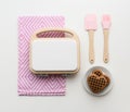 Stylish wooden play kitchen utensils. Wooden waffle maker, waffles, spatula and brush on white background copy space Royalty Free Stock Photo