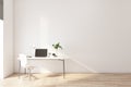 Stylish work place with modern laptop on white table, white chair near on light wall background Royalty Free Stock Photo