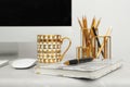 Stylish workplace with different golden accessories. Idea for interior design