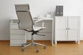 Stylish workplace interior with office chair and desk