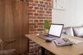 Workplace desk with laptop nobody home