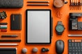 Stylish Workspace Flat Lay Featuring Tablet and Office Items on Orange Background Royalty Free Stock Photo