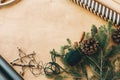 Stylish wrapping paper, wooden star, pine branches and cones, thread on rural wooden table, copy space. Rustic christmas still