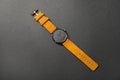 Stylish wrist watch on dark background, top view