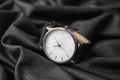 Stylish wrist watch on dark fabric Royalty Free Stock Photo