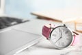 Stylish wrist watch on office table, space for text. Royalty Free Stock Photo