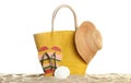 Stylish yellow bag and beach accessories on sand a Royalty Free Stock Photo