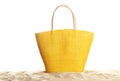 Stylish yellow bag on sand against white Royalty Free Stock Photo