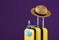 Stylish yellow suitcase with protective mask, sunglasses, hat and antiseptic spray on purple background, space for text.