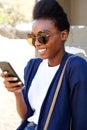 Stylish young african woman using mobile phone Royalty Free Stock Photo