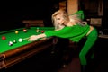 Stylish young beautiful blonde plays pool billiard Royalty Free Stock Photo