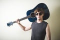 Stylish young blonde hipster man playing guitar Royalty Free Stock Photo