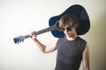 Stylish young blonde hipster man playing guitar Royalty Free Stock Photo