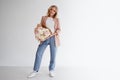 Stylish young blonde woman with a bouquet of gypsophila. Portrait on a white background.