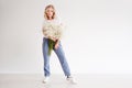 Stylish young blonde woman with a bouquet of gypsophila. Portrait on a white background.