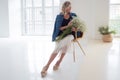 Stylish young blonde woman with a bouquet of gypsophila.