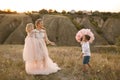 Stylish young boy gives a big flower to his mom in a field at sunset Royalty Free Stock Photo