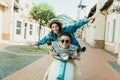 Stylish young couple riding scooter and smiling at camera Royalty Free Stock Photo